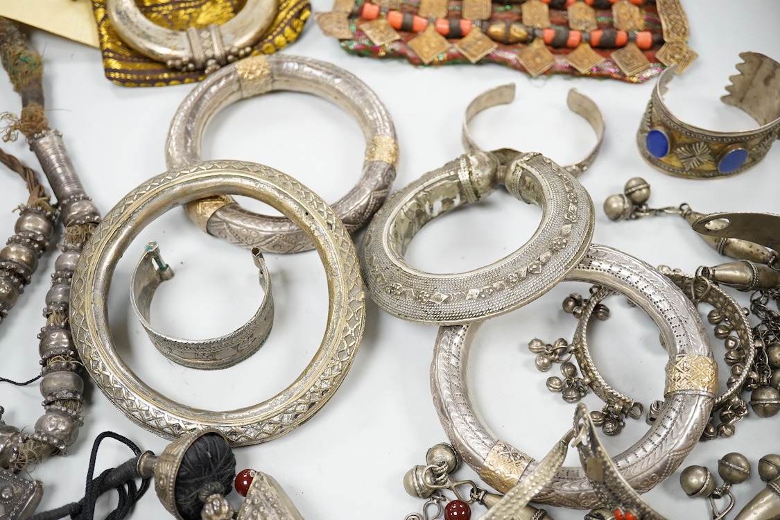 A collection of Bedouin white metal, gilt metal, lapis lazuli mounted jewellery, etc. from Oman